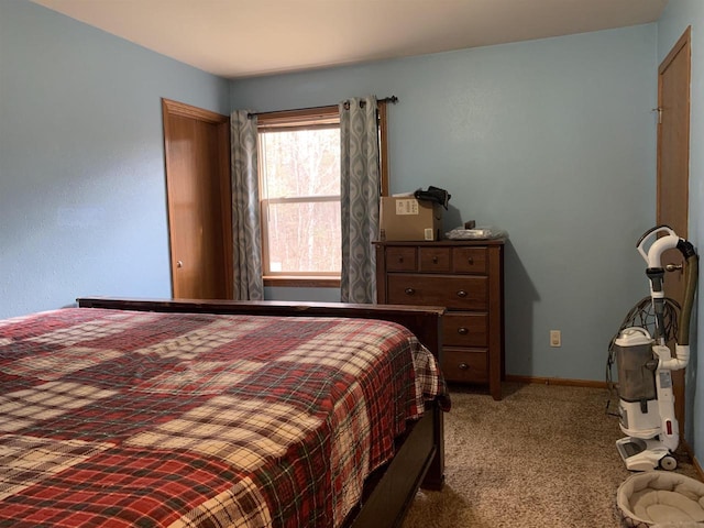 carpeted bedroom featuring baseboards