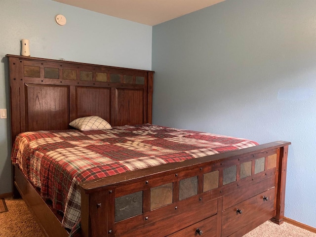 bedroom with baseboards and light carpet