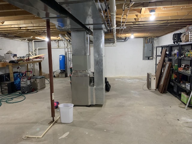 unfinished basement with electric panel and heating unit