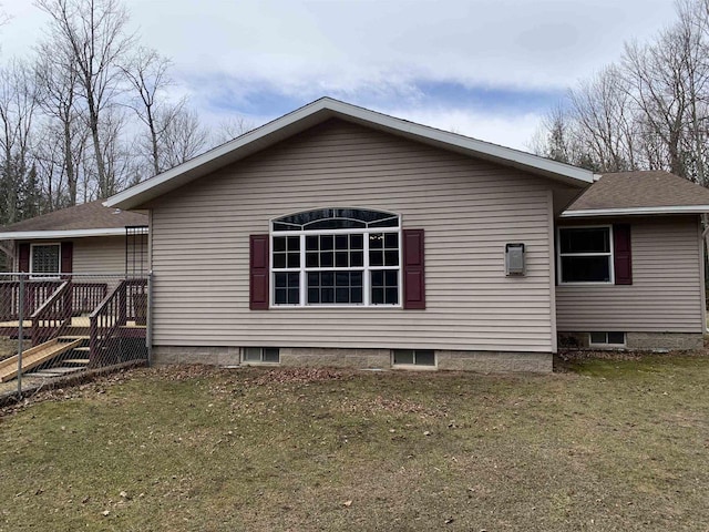 rear view of property with a lawn