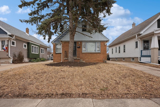 bungalow-style house featuring brick siding and board and batten siding