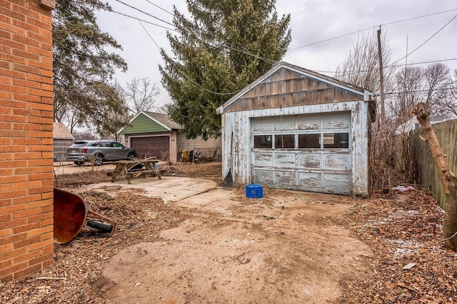 view of yard featuring a garage, an outdoor structure, and fence