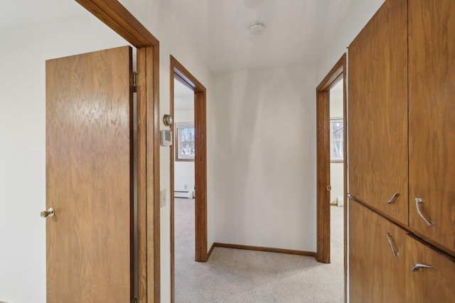 5607 Alben Ave, Mcfarland, WI 53558 - corridor featuring a wealth of natural light, light colored carpet, a baseboard heating unit, and baseboards