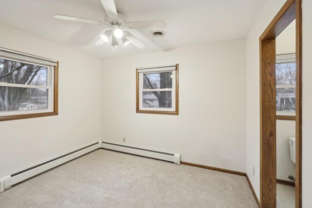 5607 Alben Ave, Mcfarland, WI 53558 - spare room featuring visible vents, light carpet, a baseboard radiator, baseboards, and ceiling fan