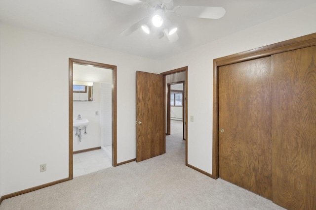 5607 Alben Ave, Mcfarland, WI 53558 - unfurnished bedroom featuring baseboards, ensuite bath, ceiling fan, a closet, and light carpet