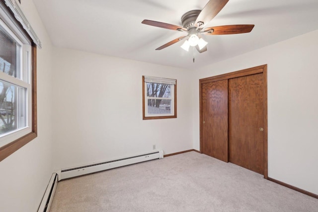 5607 Alben Ave, Mcfarland, WI 53558 - unfurnished bedroom with a ceiling fan, baseboards, a baseboard radiator, a closet, and light carpet