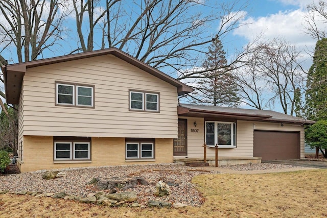 5607 Alben Ave, Mcfarland, WI 53558 - split level home featuring an attached garage and driveway