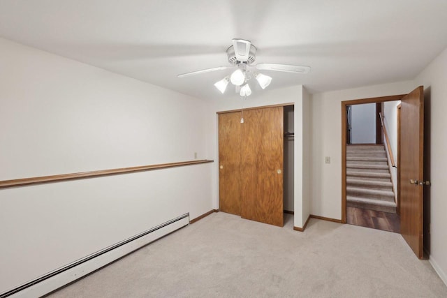 5607 Alben Ave, Mcfarland, WI 53558 - unfurnished bedroom featuring baseboards, a baseboard radiator, ceiling fan, a closet, and light carpet