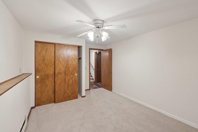 5607 Alben Ave, Mcfarland, WI 53558 - unfurnished bedroom with carpet, baseboards, ceiling fan, a closet, and baseboard heating