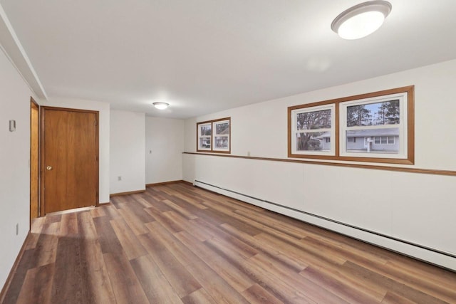 5607 Alben Ave, Mcfarland, WI 53558 - interior space with a baseboard heating unit, baseboards, and wood finished floors