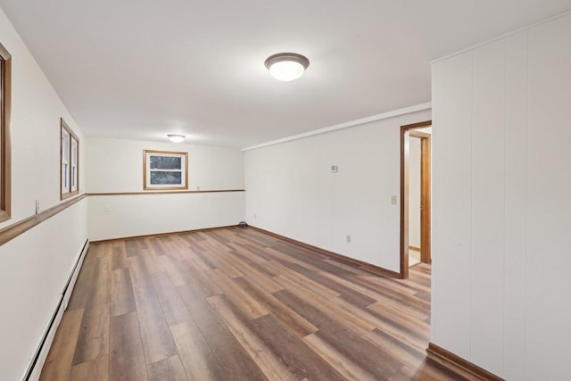 5607 Alben Ave, Mcfarland, WI 53558 - empty room with wood finished floors and a baseboard radiator