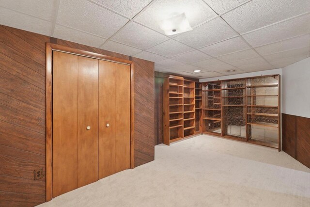5607 Alben Ave, Mcfarland, WI 53558 - interior space featuring a closet, carpet flooring, wood walls, and a drop ceiling