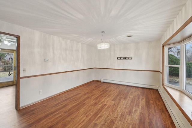 5607 Alben Ave, Mcfarland, WI 53558 - spare room with a baseboard radiator and wood finished floors