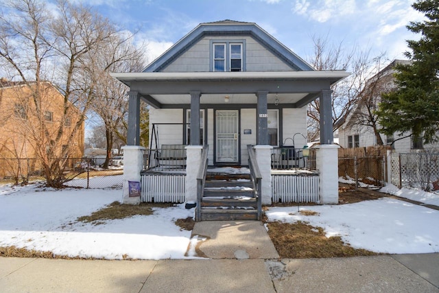 bungalow-style home featuring a porch and fence