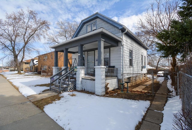 view of front of home featuring a porch and fence