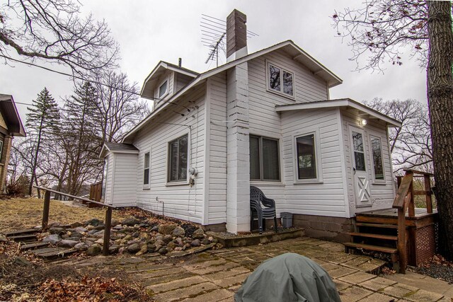 W9404 Porter Dr Unit W9408, Cambridge, WI 53523 - rear view of house featuring a patio and a chimney