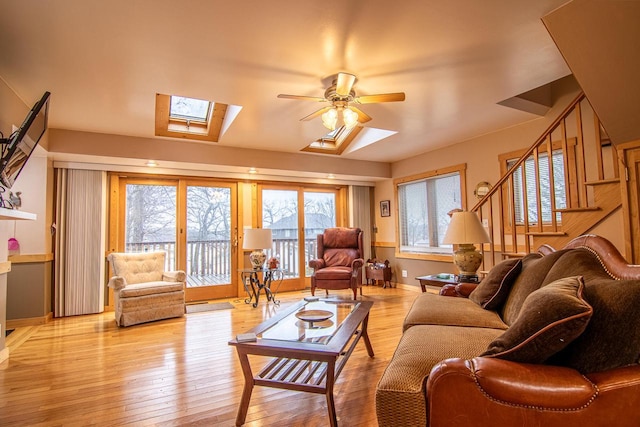 W9404 Porter Dr Unit W9408, Cambridge, WI 53523 - living room featuring stairway, a skylight, light wood-type flooring, and a ceiling fan