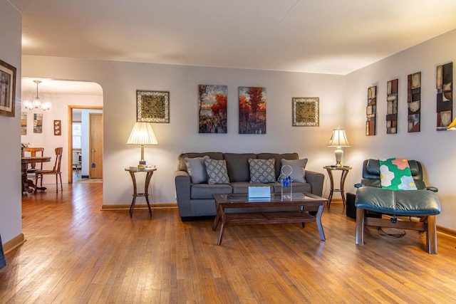 W9404 Porter Dr Unit W9408, Cambridge, WI 53523 - living area with hardwood / wood-style flooring, a notable chandelier, arched walkways, and baseboards