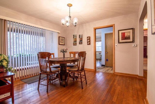 W9404 Porter Dr Unit W9408, Cambridge, WI 53523 - dining space with baseboards, an inviting chandelier, and hardwood / wood-style floors