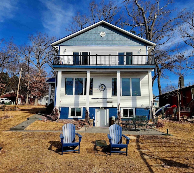 E13609 Idlewild Rd, Merrimac, WI 53561 - view of front of house featuring a balcony, a front lawn, and a patio