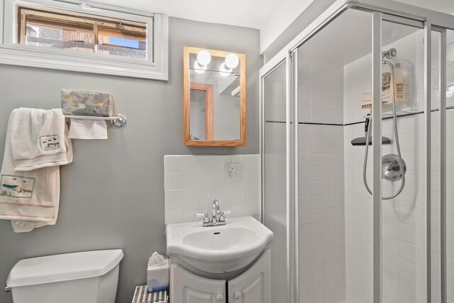 E13609 Idlewild Rd, Merrimac, WI 53561 - full bath featuring toilet, vanity, and a stall shower