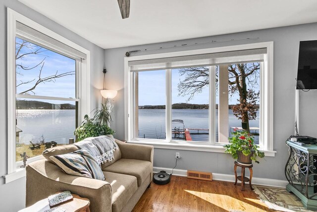 E13609 Idlewild Rd, Merrimac, WI 53561 - living area with a water view, visible vents, a healthy amount of sunlight, and wood finished floors