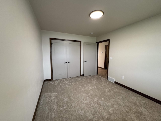 710 Tambour Ct Unit 3, De Pere, WI 54115 - unfurnished bedroom with baseboards, carpet flooring, and a closet