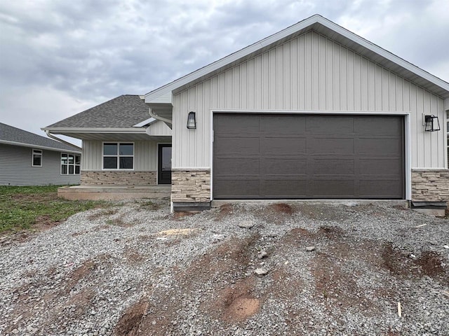 710 Tambour Ct Unit 3, De Pere, WI 54115 - view of front of property featuring stone siding, a shingled roof, and board and batten siding