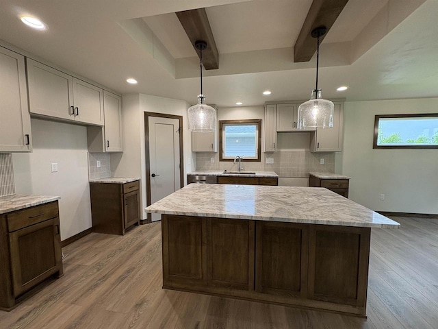 710 Tambour Ct Unit 3, De Pere, WI 54115 - kitchen featuring a sink, a center island, backsplash, wood finished floors, and recessed lighting
