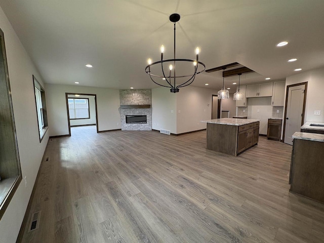 710 Tambour Ct Unit 3, De Pere, WI 54115 - kitchen featuring a center island, recessed lighting, wood finished floors, open floor plan, and a chandelier