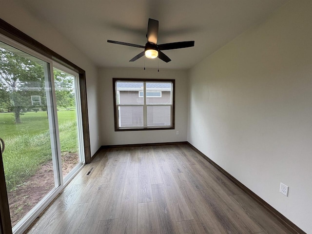 710 Tambour Ct Unit 3, De Pere, WI 54115 - unfurnished room with healthy amount of natural light, wood finished floors, baseboards, and a ceiling fan