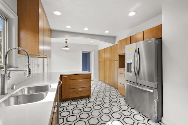 1203 Hewitt St, Neenah, WI 54956 - kitchen with a sink, a peninsula, stainless steel fridge with ice dispenser, light countertops, and decorative backsplash