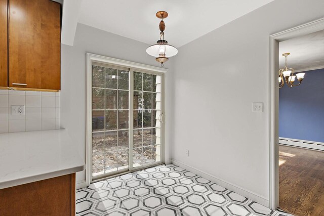 1203 Hewitt St, Neenah, WI 54956 - unfurnished dining area featuring a notable chandelier, baseboards, baseboard heating, and light floors