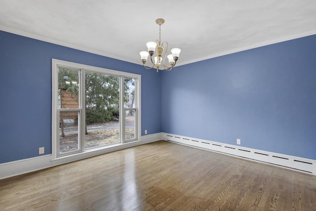 1203 Hewitt St, Neenah, WI 54956 - empty room with wood finished floors, baseboards, crown molding, a notable chandelier, and baseboard heating
