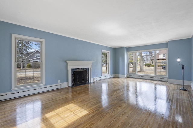 1203 Hewitt St, Neenah, WI 54956 - unfurnished living room with baseboard heating, ornamental molding, and wood finished floors