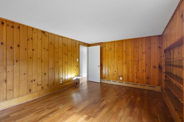 1203 Hewitt St, Neenah, WI 54956 - spare room with baseboard heating and hardwood / wood-style flooring