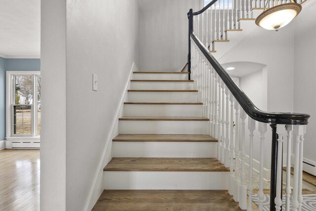 1203 Hewitt St, Neenah, WI 54956 - stairway with crown molding, wood finished floors, and arched walkways