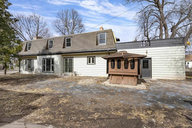 1203 Hewitt St, Neenah, WI 54956 - rear view of house with mansard roof, roof with shingles, and a chimney