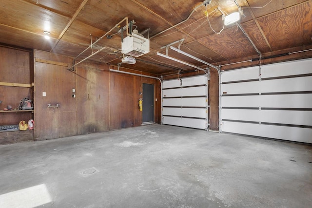 1203 Hewitt St, Neenah, WI 54956 - garage with a garage door opener and wood walls