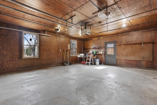 1203 Hewitt St, Neenah, WI 54956 - garage with wood walls and a garage door opener