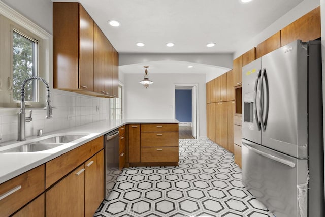 1203 Hewitt St, Neenah, WI 54956 - kitchen with backsplash, light countertops, appliances with stainless steel finishes, a peninsula, and a sink