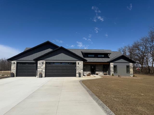 3814 W Fieldwood Dr, Janesville, WI 53545 - view of front of property with stone siding, board and batten siding, concrete driveway, and an attached garage