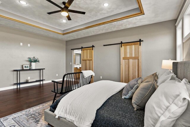 3814 W Fieldwood Dr, Janesville, WI 53545 - bedroom with baseboards, a barn door, recessed lighting, wood finished floors, and a raised ceiling