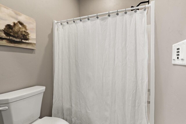 3814 W Fieldwood Dr, Janesville, WI 53545 - bathroom with toilet and a shower with shower curtain