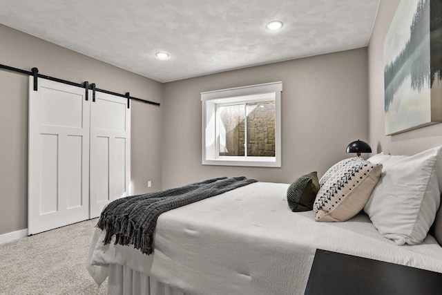 3814 W Fieldwood Dr, Janesville, WI 53545 - carpeted bedroom with a closet, recessed lighting, baseboards, and a barn door