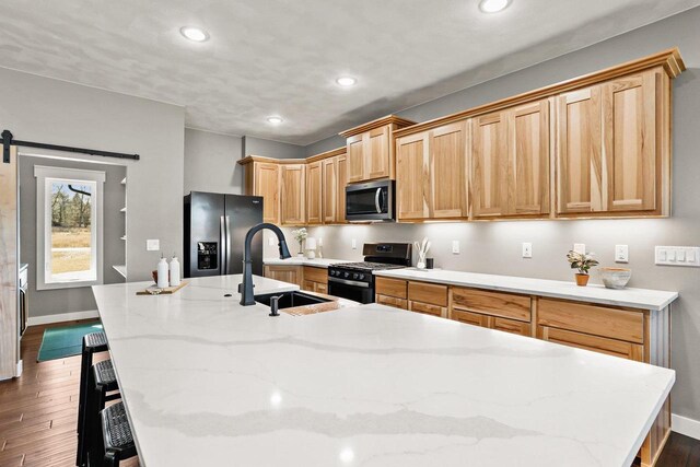 3814 W Fieldwood Dr, Janesville, WI 53545 - kitchen with a sink, stainless steel appliances, an island with sink, and dark wood-style flooring