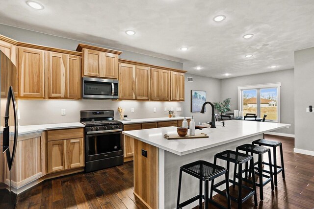 3814 W Fieldwood Dr, Janesville, WI 53545 - kitchen with stainless steel microwave, dark wood-style floors, gas stove, and a sink