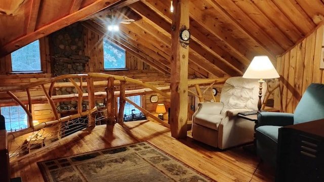 N4774 11th Dr, Montello, WI 53949 - unfurnished room with wood-type flooring, wood walls, plenty of natural light, an upstairs landing, and high vaulted ceiling
