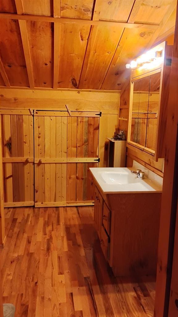 N4774 11th Dr, Montello, WI 53949 - bathroom featuring wood ceiling, wood walls, wood finished floors, and vanity