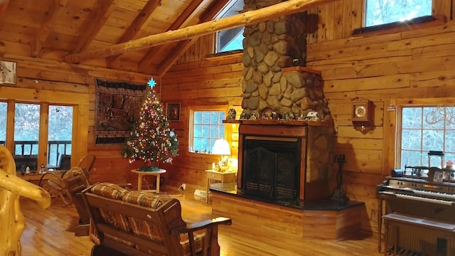 N4774 11th Dr, Montello, WI 53949 - living area featuring beam ceiling, wood finished floors, wood walls, a fireplace, and wooden ceiling